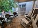 Inviting screened porch featuring tile flooring, comfortable seating, and serene views of lush greenery at 1309 Bartlett Cir, Hillsborough, NC 27278