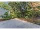 Secluded backyard patio with lush landscaping, pergola and concrete slab at 1344 Baez St, Raleigh, NC 27608