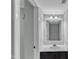 Simple bathroom with a single sink vanity, white trim, and light fixtures at 1344 Baez St, Raleigh, NC 27608
