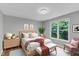 Comfortable bedroom with a soft bed, cozy linens, wooden furniture, and large window at 1344 Baez St, Raleigh, NC 27608