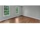This bedroom has gleaming floors and two bright windows at 1344 Baez St, Raleigh, NC 27608