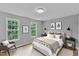 Calm bedroom featuring a soft bed with side tables, neutral decor, and large windows at 1344 Baez St, Raleigh, NC 27608