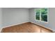 An empty bedroom has gleaming floors and a bright window at 1344 Baez St, Raleigh, NC 27608