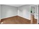 A large bedroom has gleaming floors and a view into another room at 1344 Baez St, Raleigh, NC 27608