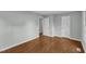 An empty bedroom has gleaming floors and white doors at 1344 Baez St, Raleigh, NC 27608