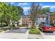 Townhouses featuring varied facades, landscaping, parking spots, and mature trees in a residential street view at 1344 Baez St, Raleigh, NC 27608