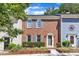 Traditional red brick townhouse with gray shutters, manicured front garden, and walkway to gray front door at 1344 Baez St, Raleigh, NC 27608