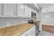Kitchen view with white cabinets, stainless steel appliances, and granite countertops at 1344 Baez St, Raleigh, NC 27608