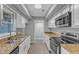 Updated kitchen with stainless steel appliances, granite countertops, and white cabinetry at 1344 Baez St, Raleigh, NC 27608