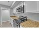 Well-lit kitchen with white cabinets, stainless steel appliances, and granite countertops at 1344 Baez St, Raleigh, NC 27608