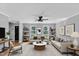 Bright living room with ceiling fan, two sofas, modern decor, and large windows at 1344 Baez St, Raleigh, NC 27608