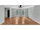 Bright living room with hardwood floors, neutral paint, and two large windows at 1344 Baez St, Raleigh, NC 27608