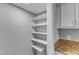 Pantry area with white walls, shelving, and granite countertop at 1344 Baez St, Raleigh, NC 27608