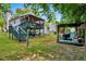 View of the home's backyard with multi-level deck, lawn, and detached pergola at 135 Crooked Creek Run, Louisburg, NC 27549