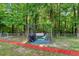 Backyard patio area with a swing bench and a grill at 135 Crooked Creek Run, Louisburg, NC 27549