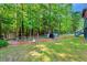 View of backyard with patio area, backyard shed and mature trees at 135 Crooked Creek Run, Louisburg, NC 27549