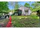 View of the home's backyard with deck, lawn, detached pergola, and mature trees for added privacy at 135 Crooked Creek Run, Louisburg, NC 27549