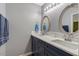 Contemporary bathroom with double sinks, quartz countertops and decorative mirrors at 135 Crooked Creek Run, Louisburg, NC 27549