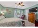 Cozy bedroom featuring a ceiling fan, carpeted floor and a window seat area at 135 Crooked Creek Run, Louisburg, NC 27549
