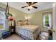 Bedroom features a window and a double bed and coordinated side tables at 135 Crooked Creek Run, Louisburg, NC 27549