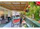 Covered porch with outdoor seating and greenery at 135 Crooked Creek Run, Louisburg, NC 27549