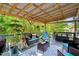 Covered porch with outdoor seating and decorative plants at 135 Crooked Creek Run, Louisburg, NC 27549