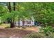 Shaded view of the front exterior of the home, showing the porch and partial side deck at 135 Crooked Creek Run, Louisburg, NC 27549