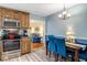 Eat-in kitchen with stainless appliances, warm wood cabinets, and stylish accents at 135 Crooked Creek Run, Louisburg, NC 27549