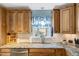 Bright kitchen featuring granite countertops, stainless steel appliances, and updated cabinetry at 135 Crooked Creek Run, Louisburg, NC 27549