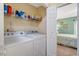 Laundry area with washer, dryer and wire shelf for cleaning supplies at 135 Crooked Creek Run, Louisburg, NC 27549