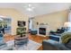 Cozy living room features hardwood floors, a fireplace, and comfortable furnishings at 135 Crooked Creek Run, Louisburg, NC 27549