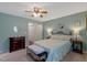 Well-lit main bedroom with ceiling fan, decorative accents and comfortable decor at 135 Crooked Creek Run, Louisburg, NC 27549