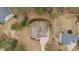This aerial view showcases a well-maintained home with a long driveway, a neutral-colored roof, and mature trees surrounding the property at 138 Tramway Cir, Angier, NC 27501