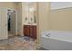 Bathroom showcasing a soaking tub, vanity, and natural light, creating a relaxing and functional space at 138 Tramway Cir, Angier, NC 27501