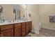 Double vanity bathroom features a large mirror, ample counter space, and warm lighting, perfect for shared use at 138 Tramway Cir, Angier, NC 27501