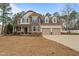 Charming two-story home featuring a covered porch, two-car garage, and beautifully manicured landscaping at 138 Tramway Cir, Angier, NC 27501