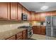 The kitchen boasts granite countertops, stainless steel appliances, and wood cabinets at 138 Tramway Cir, Angier, NC 27501