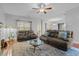 Spacious living room featuring hardwood floors, comfortable leather seating, and bright natural light at 138 Tramway Cir, Angier, NC 27501