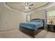 Serene main bedroom featuring a trey ceiling, a plush bed, and matching dark wood furniture at 138 Tramway Cir, Angier, NC 27501