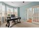Bright office space with a large desk, natural light, and an open doorway leading to the home's interior at 138 Tramway Cir, Angier, NC 27501