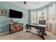 Comfortable home office with a wooden desk, a plush chair, and soft natural light from the window at 138 Tramway Cir, Angier, NC 27501