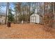 Backyard of home featuring a utility shed and wooded area at 138 Tramway Cir, Angier, NC 27501