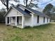 Exterior view of a white one-story home with a blue roof and a covered front porch at 1400 Hargrove St, Rocky Mount, NC 27801
