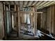 Interior view of a gutted home with exposed framing and concrete flooring at 1400 Hargrove St, Rocky Mount, NC 27801