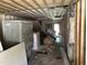 Interior view of a gutted home with exposed framing, open ceilings, and concrete flooring at 1400 Hargrove St, Rocky Mount, NC 27801