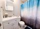 Bathroom with a white vanity, decorative mirror, toilet, and blue shower curtain at 141 Jones Franklin Rd # E, Raleigh, NC 27606