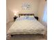 Bedroom with queen bed and blue and patterned linens at 141 Jones Franklin Rd # E, Raleigh, NC 27606