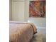 Bedroom with decorative painting and a bed with patterned linens at 141 Jones Franklin Rd # E, Raleigh, NC 27606