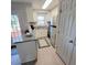Well-lit kitchen features a combination of white cabinets, stainless steel appliances, and granite countertops at 141 Jones Franklin Rd # E, Raleigh, NC 27606