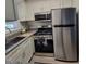 Kitchen featuring stainless steel appliances, granite countertops, and white cabinets, offering modern conveniences at 141 Jones Franklin Rd # E, Raleigh, NC 27606
